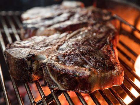 cooking a t bone steak on a gas grill